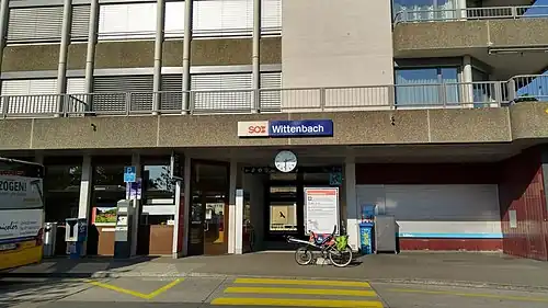 Station with flat-roofed one story entrance and office space above