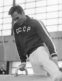 Yuri Titov: Olympic champion, four-time world champion, eight-time European champion, and later president of the International Gymnastics Federation. (Behind Lisitsky, in profile).