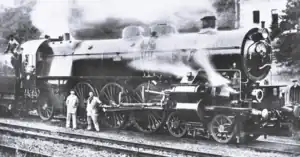 steam locomotive with crew in front of it