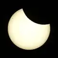 A photo of the 2025-03-29 partial solar eclipse, showing one larger and several smaller sunspots