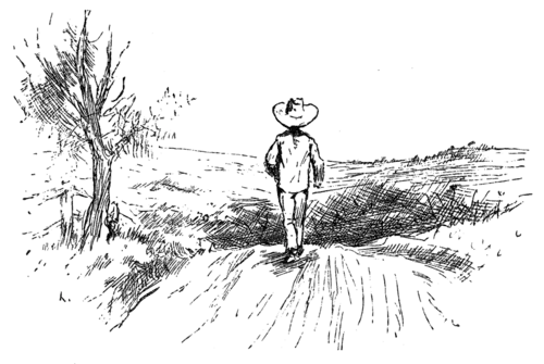 boy walking along road through open country