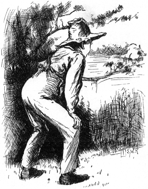 boy crouched behind a tree, looking out over the water