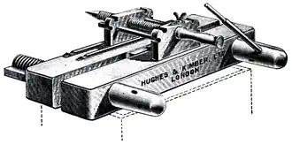 Cross-hatched drawing of a heavy, flat, clamp-like device.