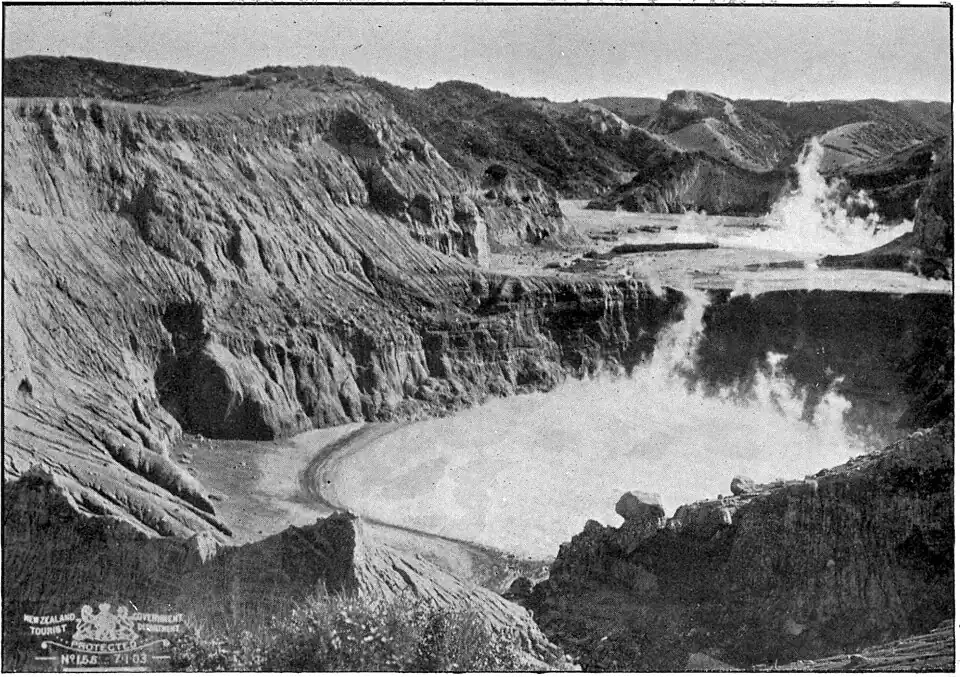 Two steaming craters surrounded by sloping rocks
