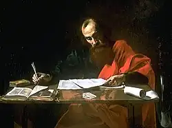 "Saint Paul Writing His Epistles": An oil painting of St Paul—a balding, bearded man with brown hair—seated at a desk, writing with a quill pen on a sheet of paper.