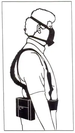 Man wearing a halfmask powered-air-purifying respirator