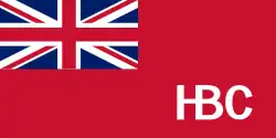 The flag of the Hudson's Bay Company: A Red Ensign, with the Union Jack in the top left corner and a stylised H.B.C logo in the bottom right.