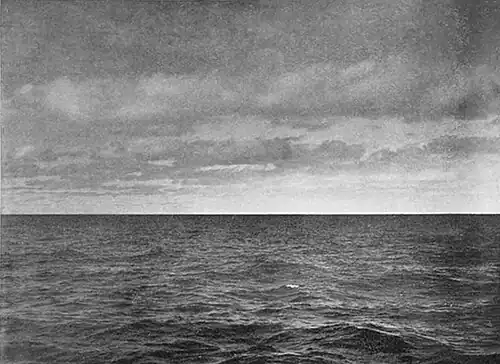 Photo of an empty sea with bright light near part of the horizon