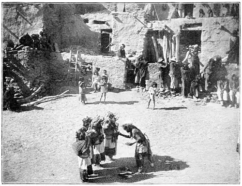 PRIEST HANDING OFFERINGS TO BASKET THROWERS