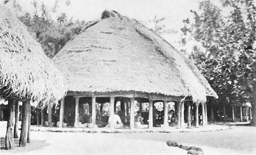 A photo of a large circular building with several persons seated inside