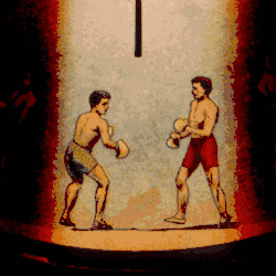 An image from a Phenakistoscope, a primitive animation device, showing two athletes boxing