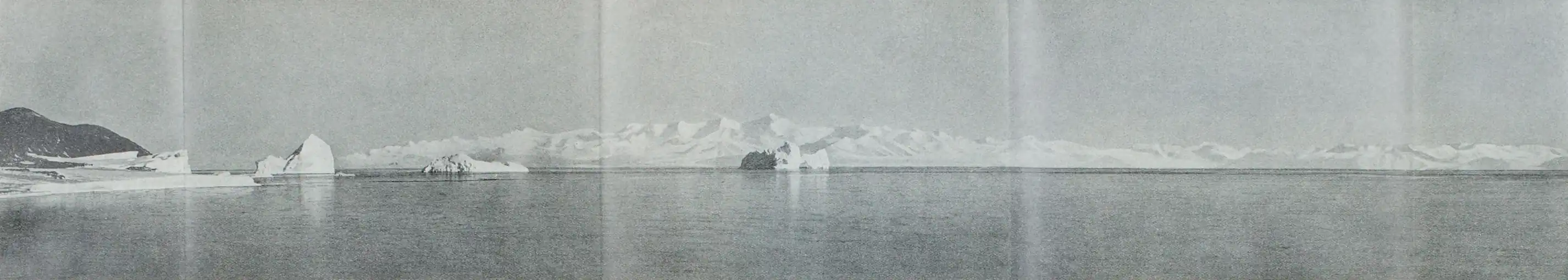 Fold-out panoramic photo of an open-water bay with snow-covered mountains in the distance