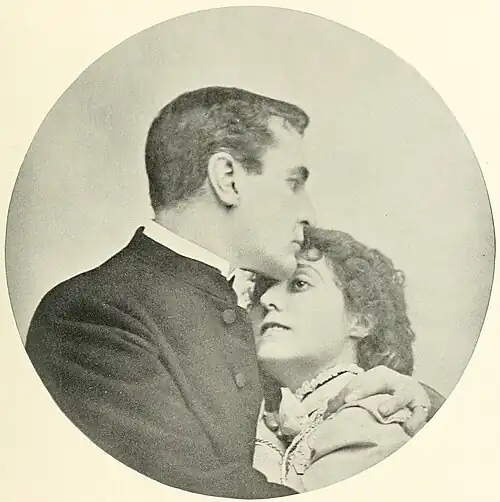 William Gillette as Sherlock Holmes embraces [Name] as Alice Faulkner in a circular vignette.