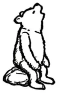 Winnie-the-Pooh sitting on a rock, looking up