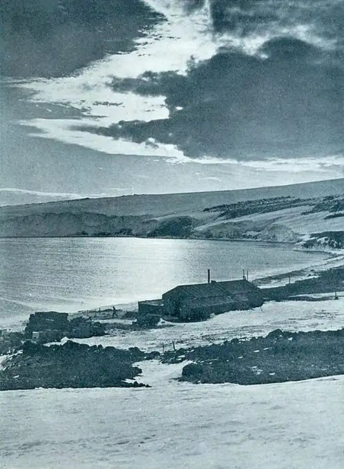 Photo of a hut near the shore of a calm bay