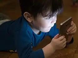 A child looks into a smartphone
