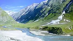 A snowy valley among mountains