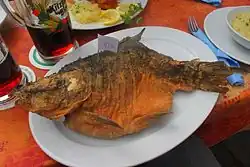 Carp baked in beer batter with price tag, price by weight