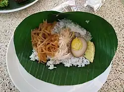 Eating on a plate that covered by a layer of banana leaf.
