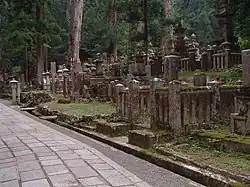 A number of vertical stone gravestones