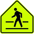 Pedestrian crossing ahead. Note the neon green color and pentagon shape.