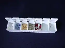A pill organizing box with seven compartments