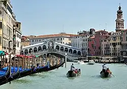 Gondoliers between buildings in Venice