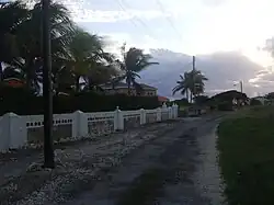 Go right past the pink house then down left.