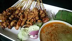 Satay with peanut sauce, onions and cucumber