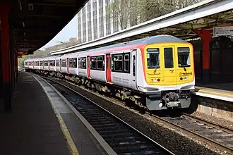 A white and red Transport for Wales train pulls into Cardiff Central